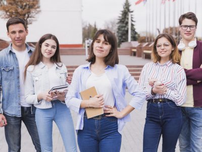 serious-men-women-standing-with-books-looking-camera